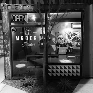 a black and white photo of a storefront