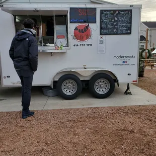 a man standing in front of a food truck