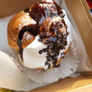 a half eaten doughnut in a box