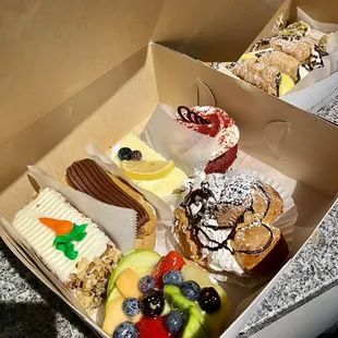 Carrot Cake Slice, Eclair, Limoncello Slice, Red Velvet Cupcake, Fruit Tart, and Cream Puff