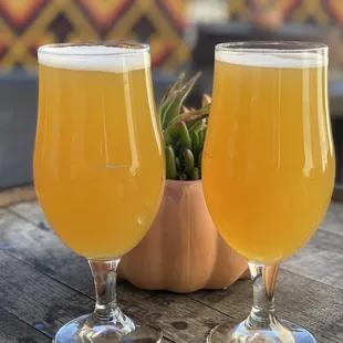 two glasses of beer on a table