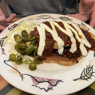 Molly's cakes ($16). Corn cake filled with poblanos, and green onions, topped with queso fresco, beans, and eggs, w/ pickled serranos.