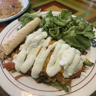Pastrami hash ($17). Hashbrowns, veggies, pastrami, cheddar, eggs, poblano sour cream, spring greens with vin, and tortillas.
