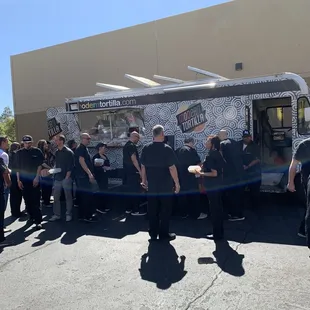 Employees enjoying some tacos.