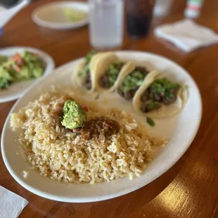 Street tacos with cilantro in Mexican rice