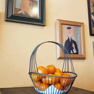 Clementines, along side a wall of art.