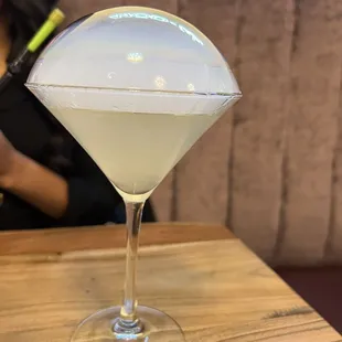 a glass of white liquid on a table