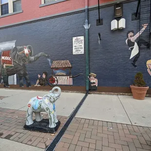 an elephant, a man, a woman and a child