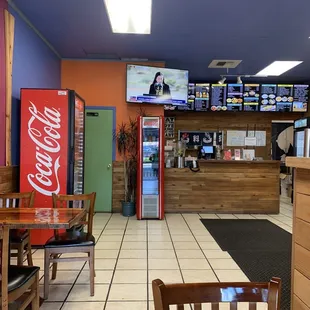 Counter area, menu board and drink coolers from back corner of dining area