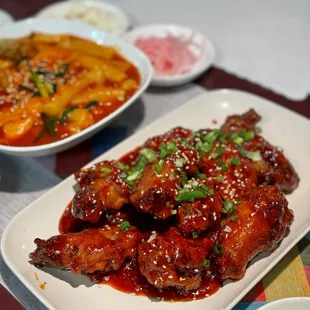 A5. Fried Chicken in Sauce: so delicious! Nice crispy chicken drenched in sticky sweet and mild spicy sauce.  (A4. Tteokbbokki in the back)