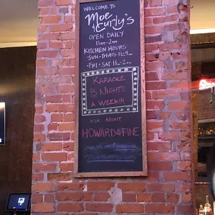 a menu on a brick wall