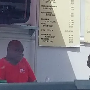 a man sitting at a food truck