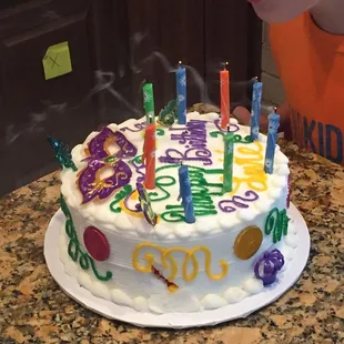 a child blowing out candles on a birthday cake