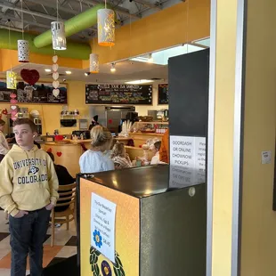 a boy standing at the counter