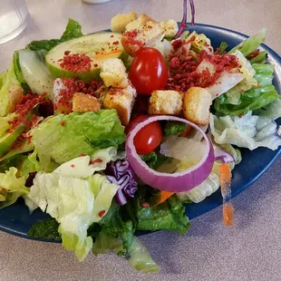 a plate of salad and a glass of water