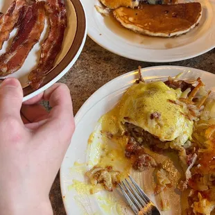 Corned beef eggs Benedict with hash browns. Blueberry pancakes with bacon.