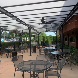 a patio with tables and chairs