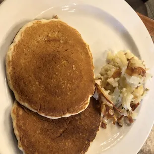 a plate of pancakes and potatoes