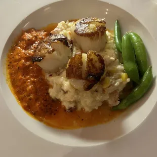 Scallops over lobster and corn risotto, snap peas, and a red pepper cream sauce that truly was spectacular