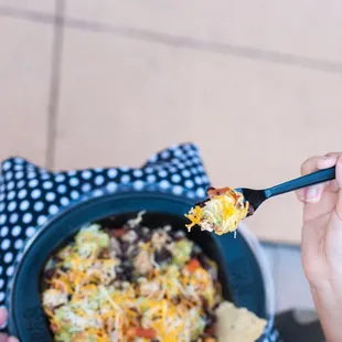 a person eating a bowl of food