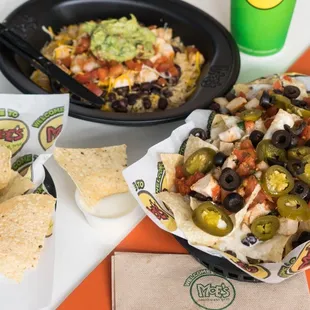 a plate of nachos and a bowl of chips