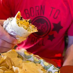 a man eating a burrito