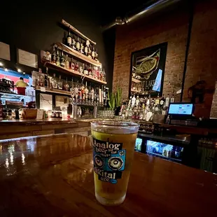 a pint of beer on a bar