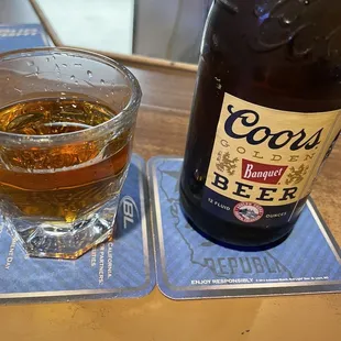 a glass of beer and a bottle of beer