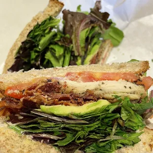 a hand holding a sandwich