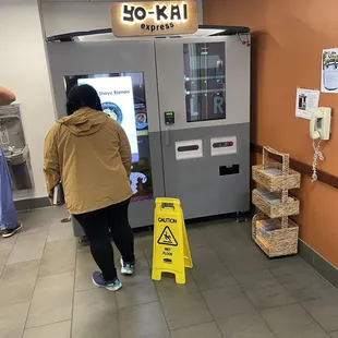 a woman entering a vending machine