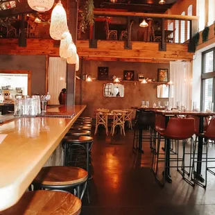 a bar with wooden tables and stools