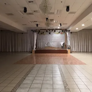 Stage, dance floor, and chandeliers.