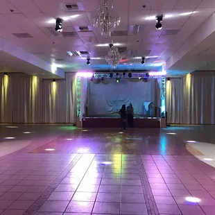 Stage and dance floor with the lights on.