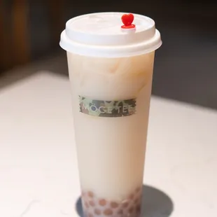 a coffee cup with a straw and a cherry on top