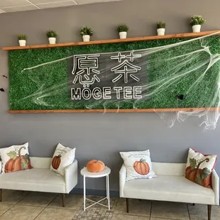 two white chairs and a green wall