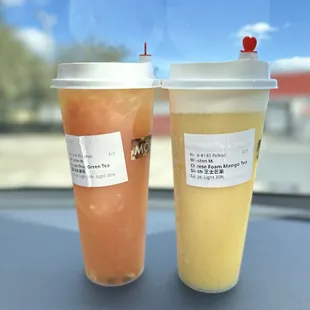 two drinks on a car dashboard