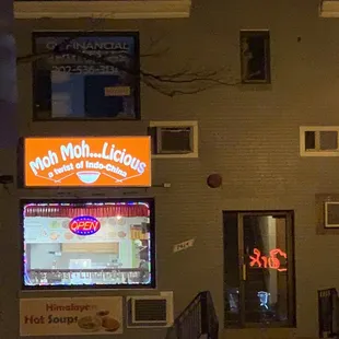 a neon sign in front of a building