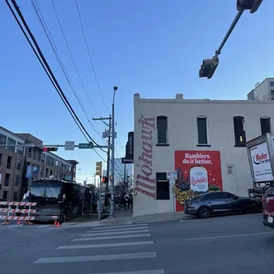 a street corner with cars parked on the side of the road