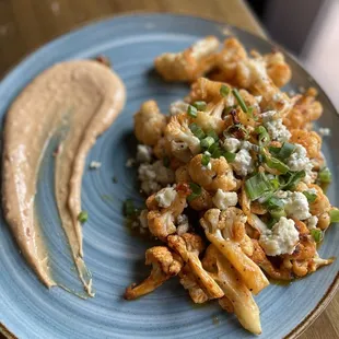 Swank Farm Cauliflower- Buffalo sauce flavored cauliflower with cheese and green onion