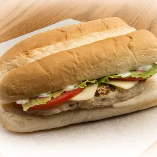 a sandwich with meat, lettuce, tomato, and cheese