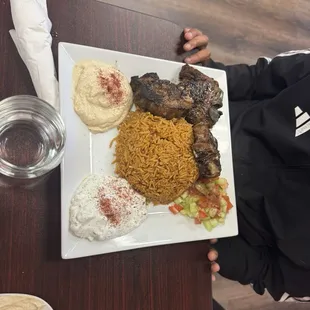 Lamb chops comes with rice, hummus and side salads.