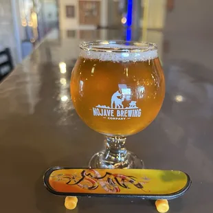 a glass of beer and a skateboard