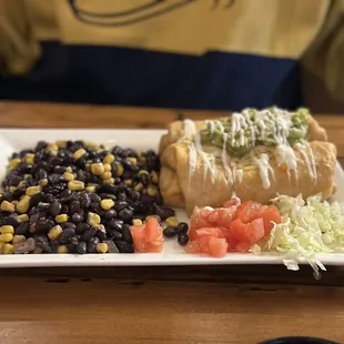 Chicken chimichanga with side of black bean corn salad