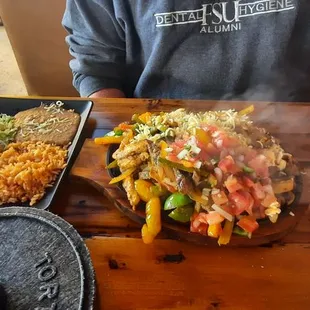 Steak and chicken fajitas, refried beans, spanish rice