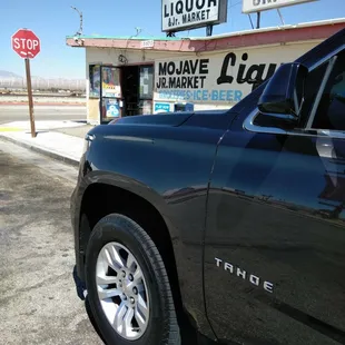 a truck parked in front of a liquor store