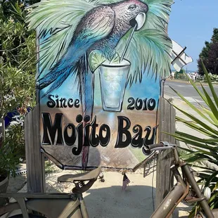 a bicycle parked in front of a sign