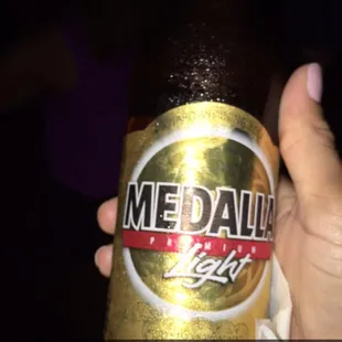 a person holding a beer bottle