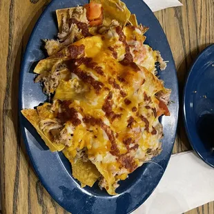 ows a plate of nachos and a bowl of salsa