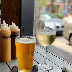 ows a glass of white wine and two bottles of beer