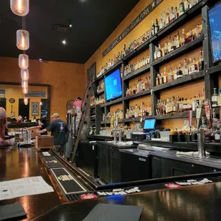 a bar with a bar counter and a television